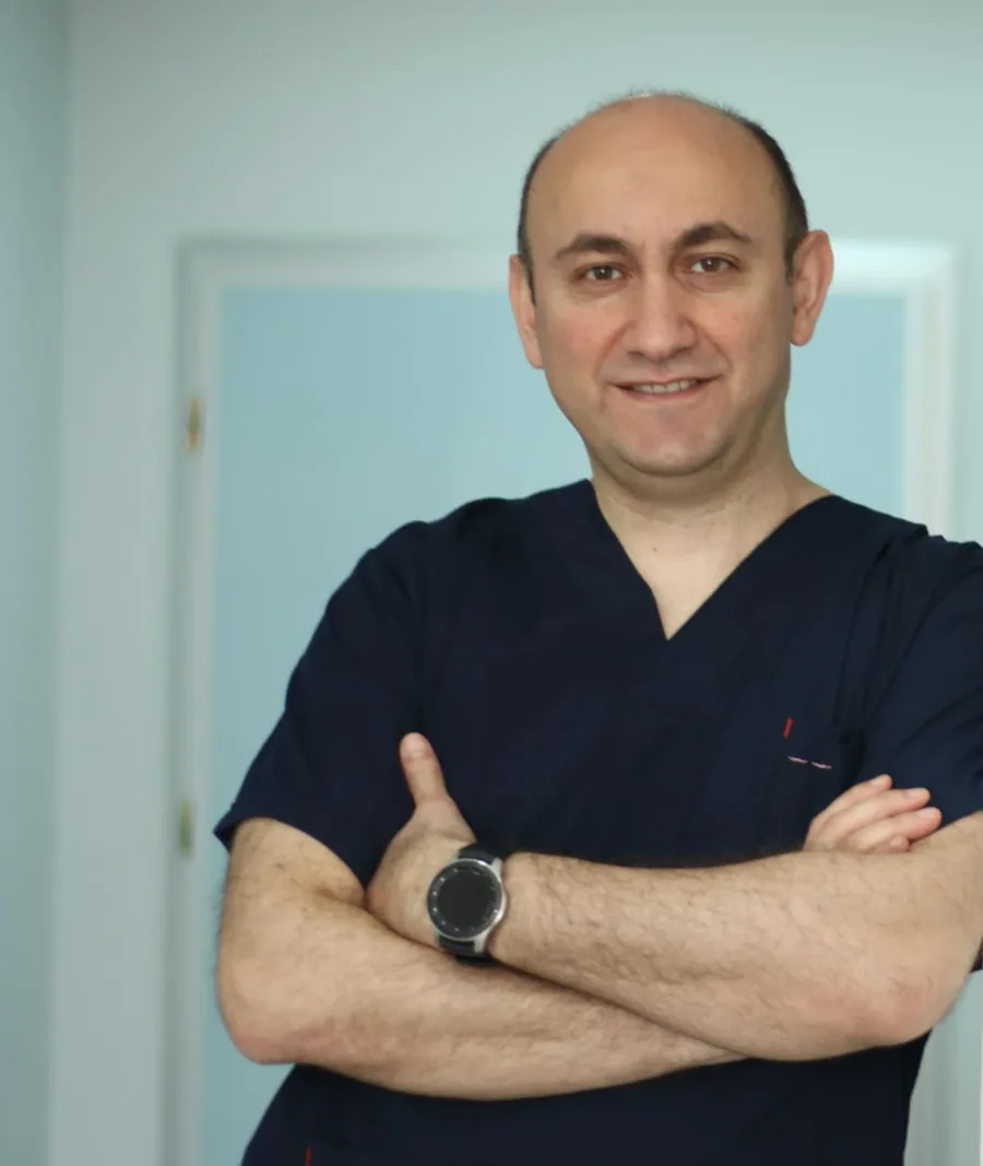 Dr. Rufat Asadbeyli in surgical scrubs at the hospital